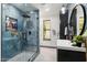 Modern bathroom with a walk-in shower, floating vanity, and marble-look tile at 1101 N Christa Way, Tolleson, AZ 85353