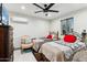 Bedroom with two twin beds, dresser, and ceiling fan at 1101 N Christa Way, Tolleson, AZ 85353