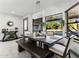 Bright dining room with a modern table and bench seating, large windows, and a chandelier at 1101 N Christa Way, Tolleson, AZ 85353