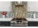 Modern kitchen with stainless steel stove and backsplash at 1101 N Christa Way, Tolleson, AZ 85353