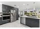 Sleek kitchen with stainless steel appliances and gray cabinets at 1101 N Christa Way, Tolleson, AZ 85353