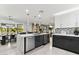 Open concept kitchen with a large island and white countertops at 1101 N Christa Way, Tolleson, AZ 85353