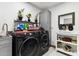Convenient laundry room with front-load washer and dryer, and ample storage at 1101 N Christa Way, Tolleson, AZ 85353