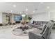 Spacious living room featuring a grey sectional sofa and fireplace at 1101 N Christa Way, Tolleson, AZ 85353