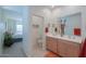 Bright bathroom boasts double sinks and a view into a bedroom at 19782 N Lauren Rd, Maricopa, AZ 85138