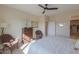 Well-lit bedroom featuring a ceiling fan and ample closet space at 19782 N Lauren Rd, Maricopa, AZ 85138