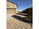 Brick paver driveway leading to a two-car garage at 39972 W Pryor Ln, Maricopa, AZ 85138