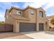 A two-story home with stucco siding, arched entryway, and a two-car garage at 41375 N Salix Dr, San Tan Valley, AZ 85140