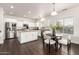 Bright white kitchen with stainless steel appliances, island, and dining area at 41375 N Salix Dr, San Tan Valley, AZ 85140