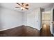 Bright bedroom with dark wood floors and access to hallway and upper level at 5544 E Paradise Ln, Scottsdale, AZ 85254