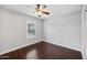 Bedroom with dark wood floors and plantation shutters at 5544 E Paradise Ln, Scottsdale, AZ 85254