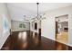 Spacious dining room with hardwood floors and a modern chandelier at 5544 E Paradise Ln, Scottsdale, AZ 85254