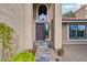 Elegant entryway with a beautiful wood door and stone walkway at 5544 E Paradise Ln, Scottsdale, AZ 85254