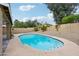Relaxing kidney-shaped pool with surrounding patio at 5544 E Paradise Ln, Scottsdale, AZ 85254