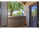 Private patio with treetop views and sliding glass door access at 6900 E Princess Dr # 1126, Phoenix, AZ 85054