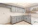 Galley kitchen, gray cabinets, and white appliances at 8027 N 32Nd Ave, Phoenix, AZ 85051