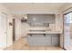 Gray kitchen with breakfast bar and access to patio at 8027 N 32Nd Ave, Phoenix, AZ 85051