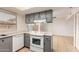 Bright eat-in kitchen with gray cabinets and white appliances at 8027 N 32Nd Ave, Phoenix, AZ 85051