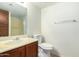 Bathroom with wood vanity, toilet, and mirror at 8201 N 21St Dr # C107, Phoenix, AZ 85021