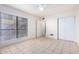 Bright bedroom with large window, tile floors and mirrored closet at 8201 N 21St Dr # C107, Phoenix, AZ 85021