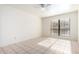 Bright bedroom with tile floors and large window with blinds at 8201 N 21St Dr # C107, Phoenix, AZ 85021