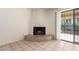Whitewashed fireplace with tile hearth in living room at 8201 N 21St Dr # C107, Phoenix, AZ 85021