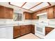 View of kitchen with wood cabinets and a window at 8201 N 21St Dr # C107, Phoenix, AZ 85021