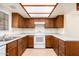 Kitchen with wood cabinets, white appliances, and tile floor at 8201 N 21St Dr # C107, Phoenix, AZ 85021