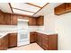 Kitchen boasts wood cabinets and a white stove at 8201 N 21St Dr # C107, Phoenix, AZ 85021