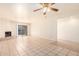 Spacious living area with tile floors, fireplace and access to patio at 8201 N 21St Dr # C107, Phoenix, AZ 85021