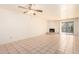 Living room with tile floors, fireplace and ceiling fan at 8201 N 21St Dr # C107, Phoenix, AZ 85021
