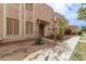 Front view of a light brown stucco condo with a walkway and landscaping at 8428 N 33Rd Dr, Phoenix, AZ 85051