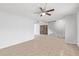 Open living room with tile floors, ceiling fan, and staircase at 8428 N 33Rd Dr, Phoenix, AZ 85051