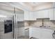 Modern kitchen with white cabinets and stainless steel appliances at 1340 N Recker Rd # 256, Mesa, AZ 85205