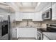 Modern kitchen with white cabinets and stainless steel appliances at 1340 N Recker Rd # 256, Mesa, AZ 85205