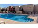 Sparkling community pool with ample lounge chairs at 1340 N Recker Rd # 256, Mesa, AZ 85205