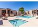Community pool and spa area with lounge chairs and patio tables at 1340 N Recker Rd # 256, Mesa, AZ 85205