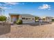 Tan single-wide manufactured home with carport and gravel landscaping at 2650 W Union Hills Dr # 155, Phoenix, AZ 85027