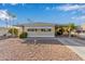 Tan single-wide manufactured home with carport and gravel landscaping at 2650 W Union Hills Dr # 155, Phoenix, AZ 85027