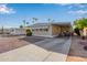 Tan single-wide manufactured home with carport and gravel landscaping at 2650 W Union Hills Dr # 155, Phoenix, AZ 85027