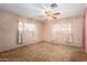 Spacious bedroom with ceiling fan and neutral carpeting at 2650 W Union Hills Dr # 250, Phoenix, AZ 85027