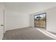 Bright bedroom with sliding glass door leading to a balcony at 4709 E Euclid Ave, Phoenix, AZ 85044