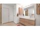 Modern bathroom with double vanity and large mirror at 5316 E Thomas Rd, Phoenix, AZ 85018