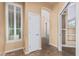 Hallway with white door, built-in shelving, and tile flooring at 7538 E Tuckey Ln, Scottsdale, AZ 85250