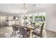 Open concept dining room with kitchen view, featuring a light wood table and access to the backyard at 7730 N 2Nd Ave, Phoenix, AZ 85021