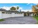 White mid-century modern home with three-car garage and paver driveway at 7730 N 2Nd Ave, Phoenix, AZ 85021