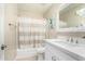 Clean bathroom with white vanity and striped shower curtain at 8351 W Taro Ln, Peoria, AZ 85382