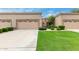 Tan stucco exterior, two-car garage, and well-manicured lawn at 8351 W Taro Ln, Peoria, AZ 85382