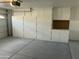 Garage with built-in storage cabinets and pegboard at 8351 W Taro Ln, Peoria, AZ 85382