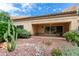 Covered patio with seating area and desert landscaping at 8351 W Taro Ln, Peoria, AZ 85382